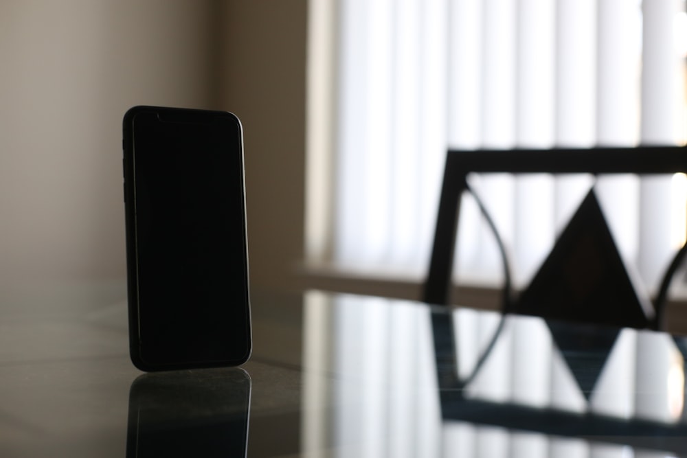 black smartphone on brown wooden table