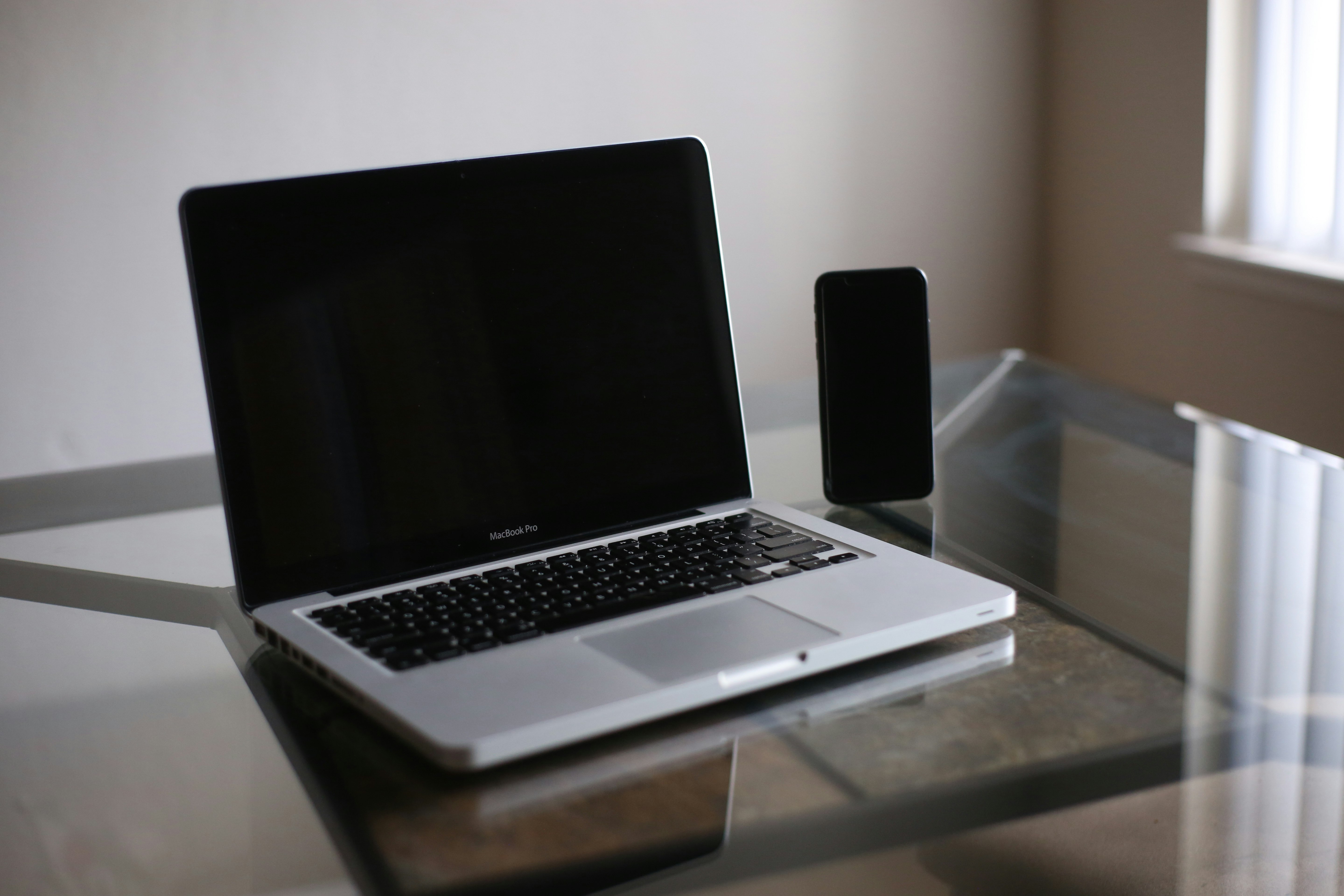 macbook pro on glass table