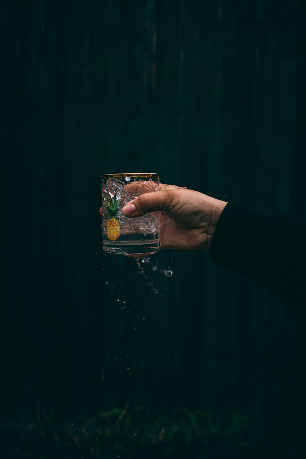 person holding clear drinking glass with water