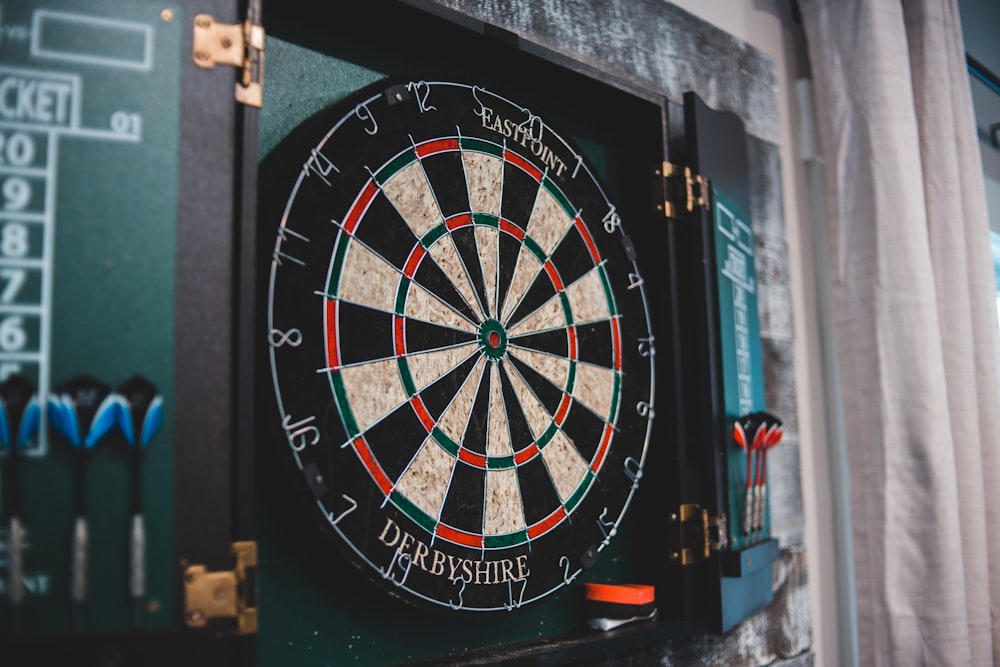 a dart board mounted to the side of a wall
