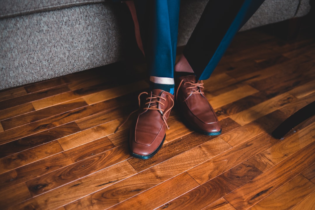 person in blue pants and brown leather shoes