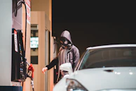 A RapidGuard team member delivering fuel to a driver stranded on a quiet suburban street.