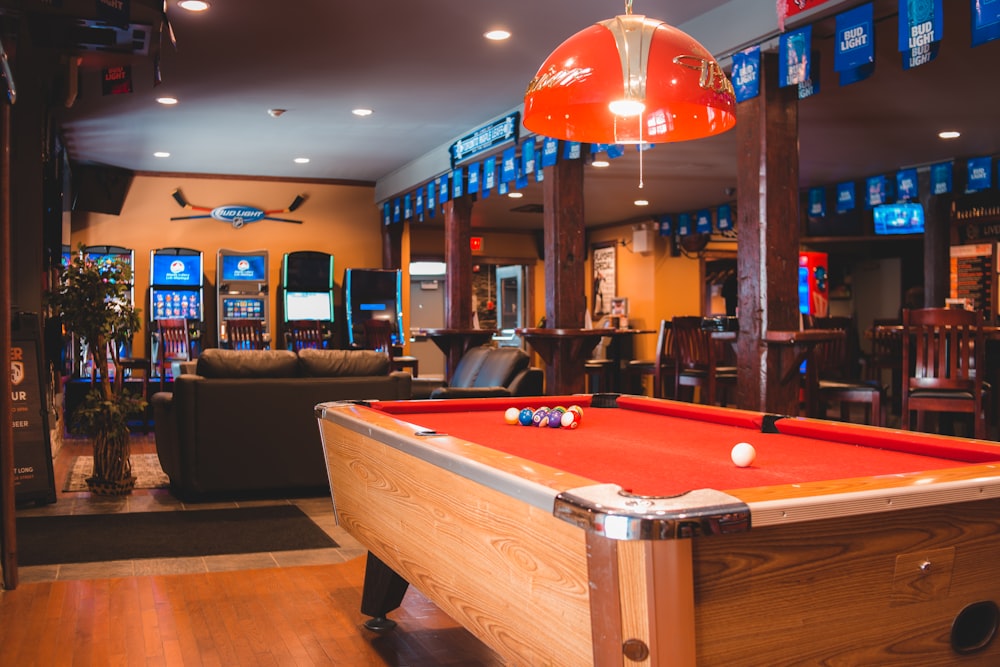 a pool table with a red cloth on it