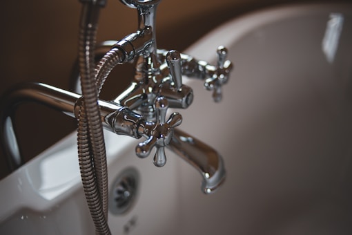 UK plumber working under sink