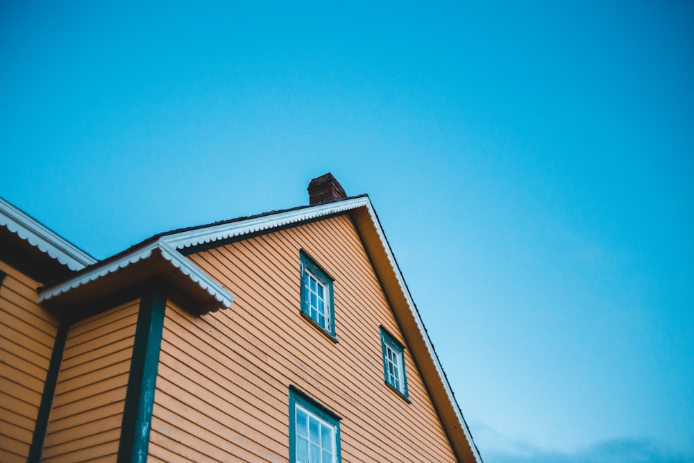 brown and white concrete house under blue sky during daytime