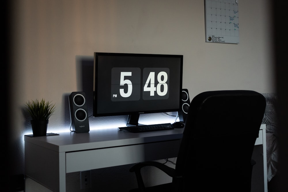 black flat screen tv on white wooden table