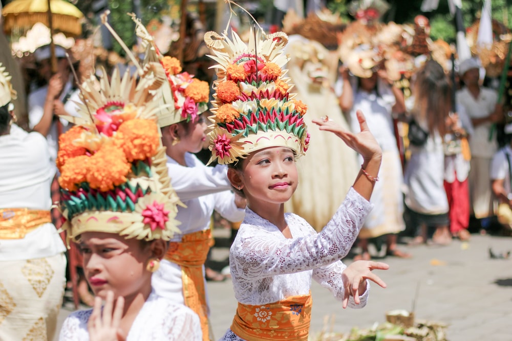 woman in white lace dress with yellow and red flower headdress