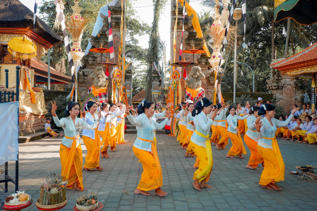 people in yellow and white robe walking on street during daytime