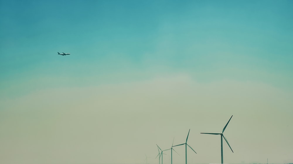 wind turbines under blue sky during daytime