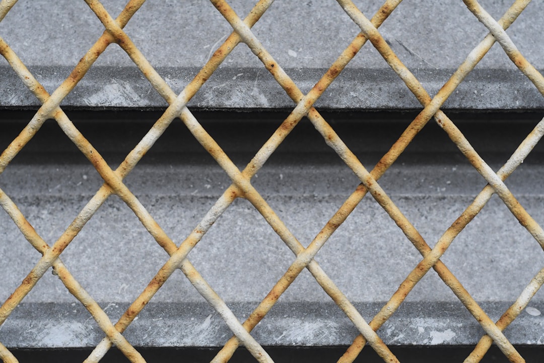 brown metal fence on gray concrete floor