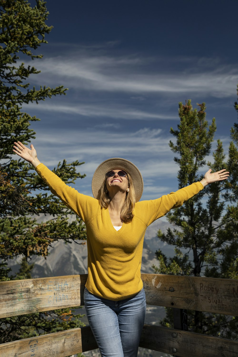 woman in yellow long sleeve shirt raising her hands