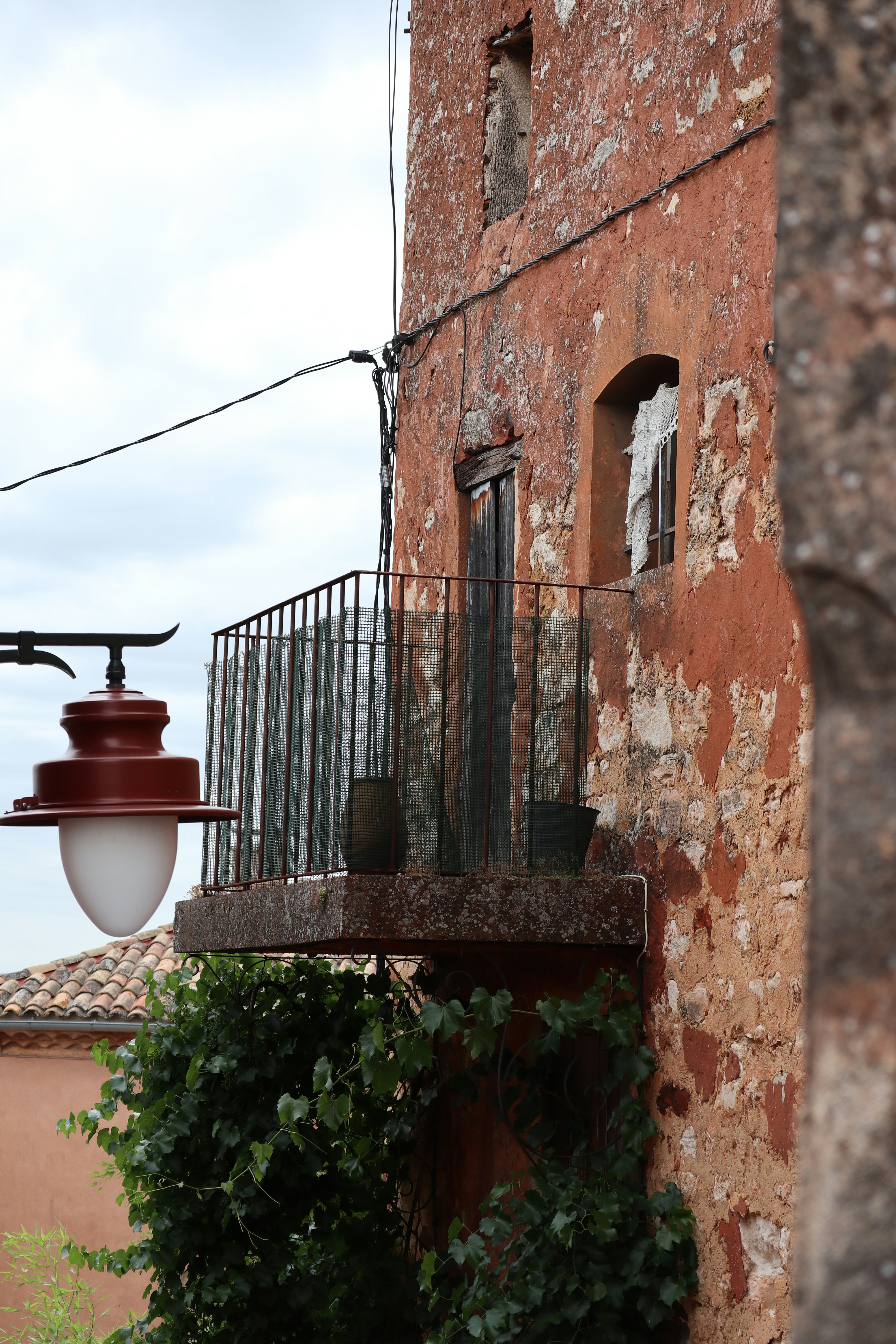 brown and black metal fire hydrant beside brown concrete wall