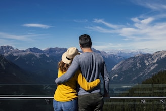man in gray and yellow long sleeve shirt and blue denim jeans standing on green grass
