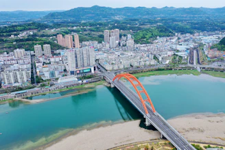 an aerial view of a bridge over a body of water