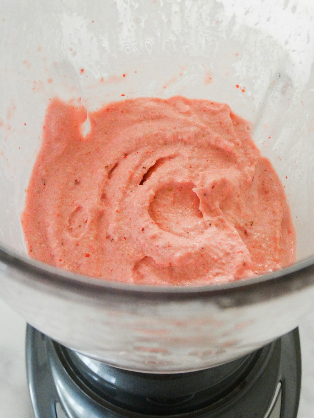 pink ice cream in clear glass bowl