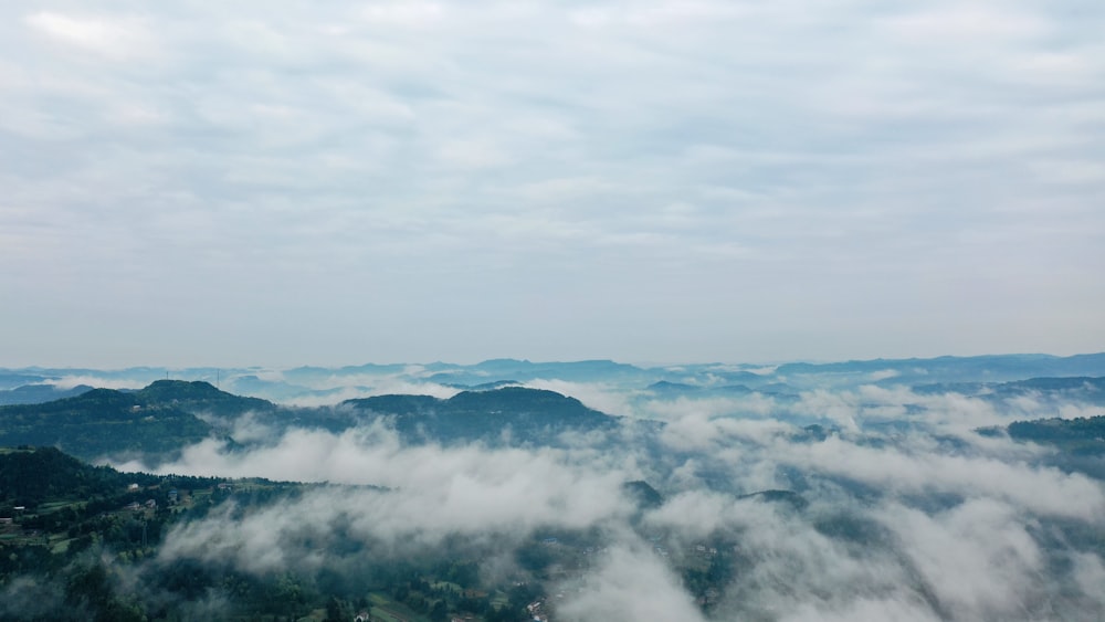 white clouds over mountains during daytime