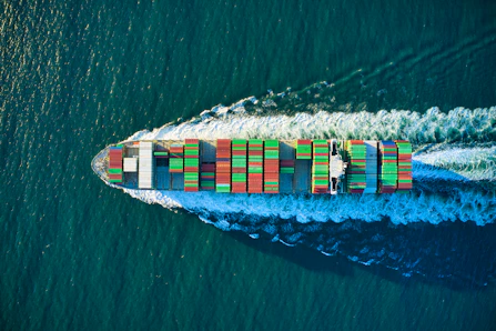 aerial view of blue and white boat on body of water during daytime