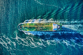 aerial view of white and yellow boat on body of water during daytime