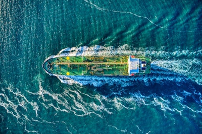 aerial view of white and yellow boat on body of water during daytime