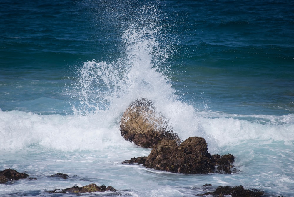 brown rock formation on sea during daytime