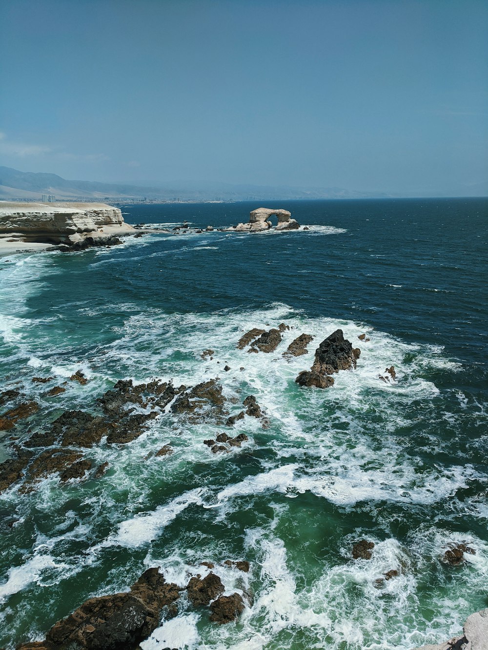 brown rock formation on sea during daytime