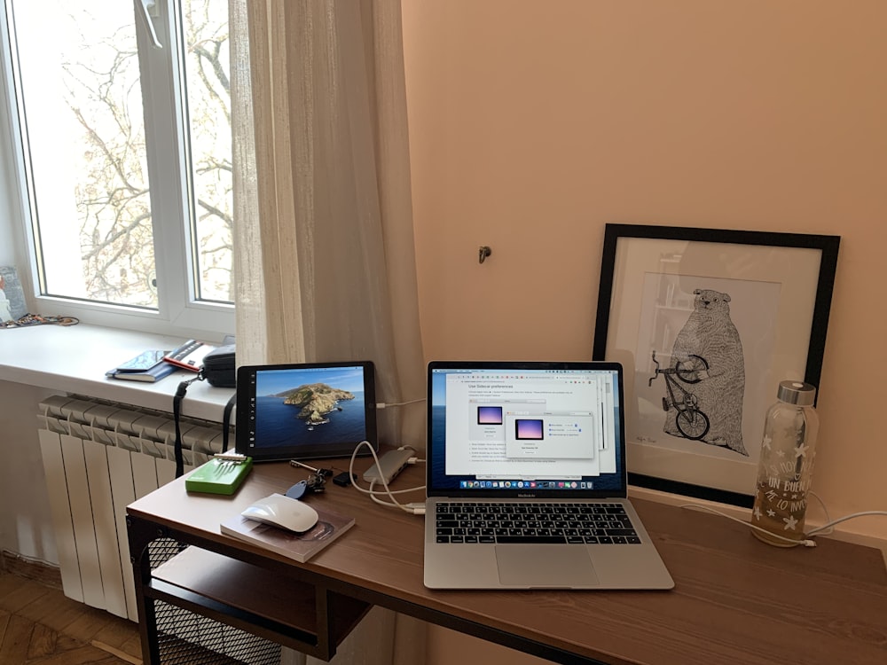 macbook pro on brown wooden table