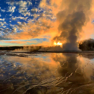 A vibrant behind-the-scenes shot of a film crew capturing a dramatic scene on location at sunset.