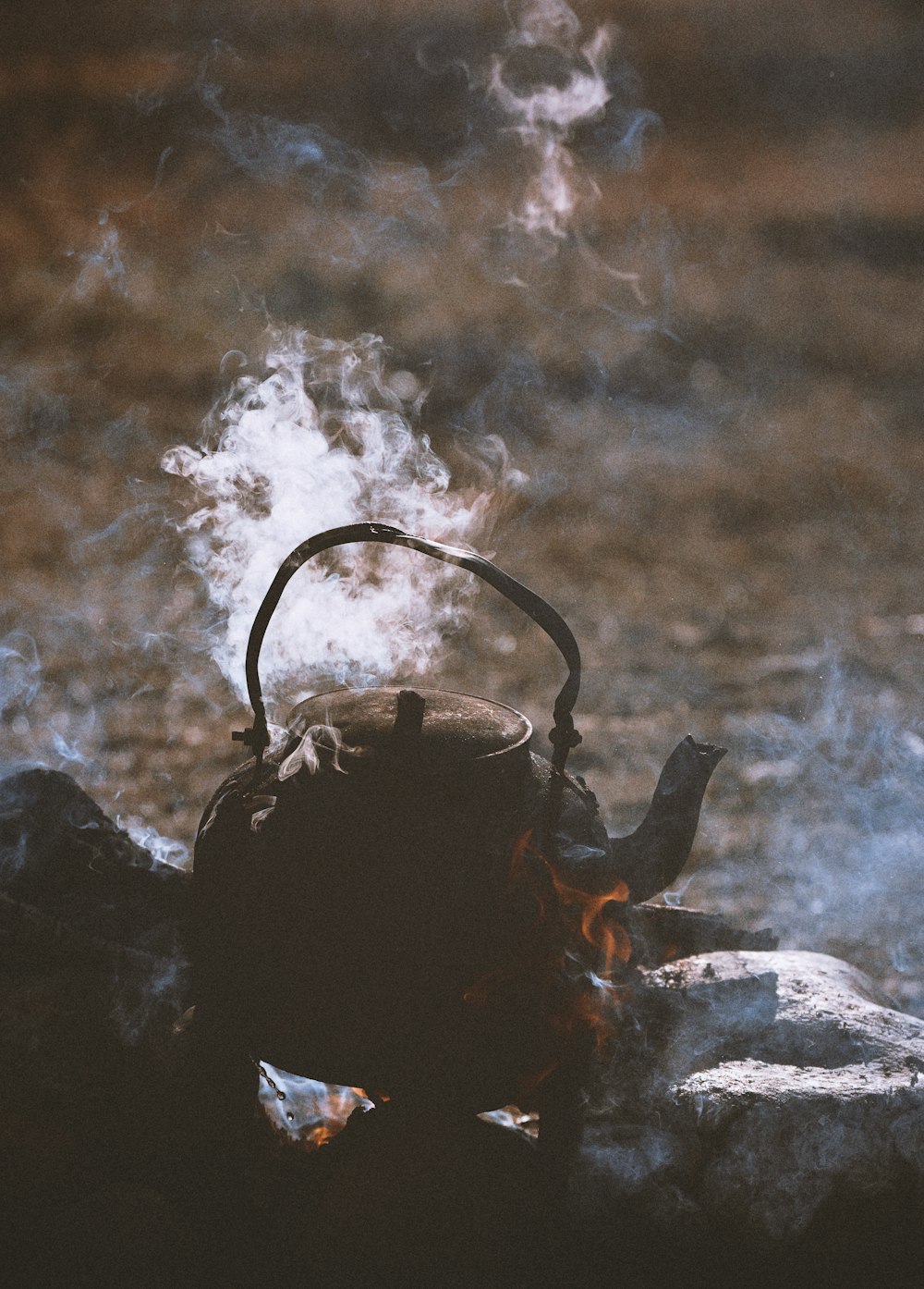 brown kettle on fire during daytime