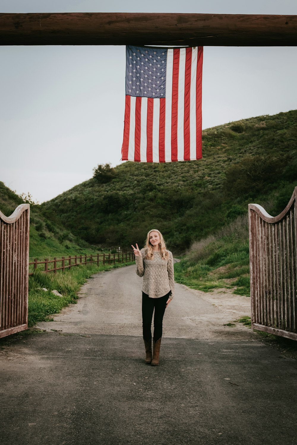 woman in brown coat standing on pathway