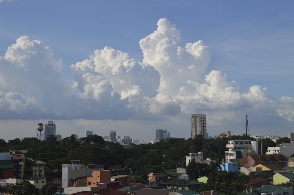 white clouds over city buildings during daytime