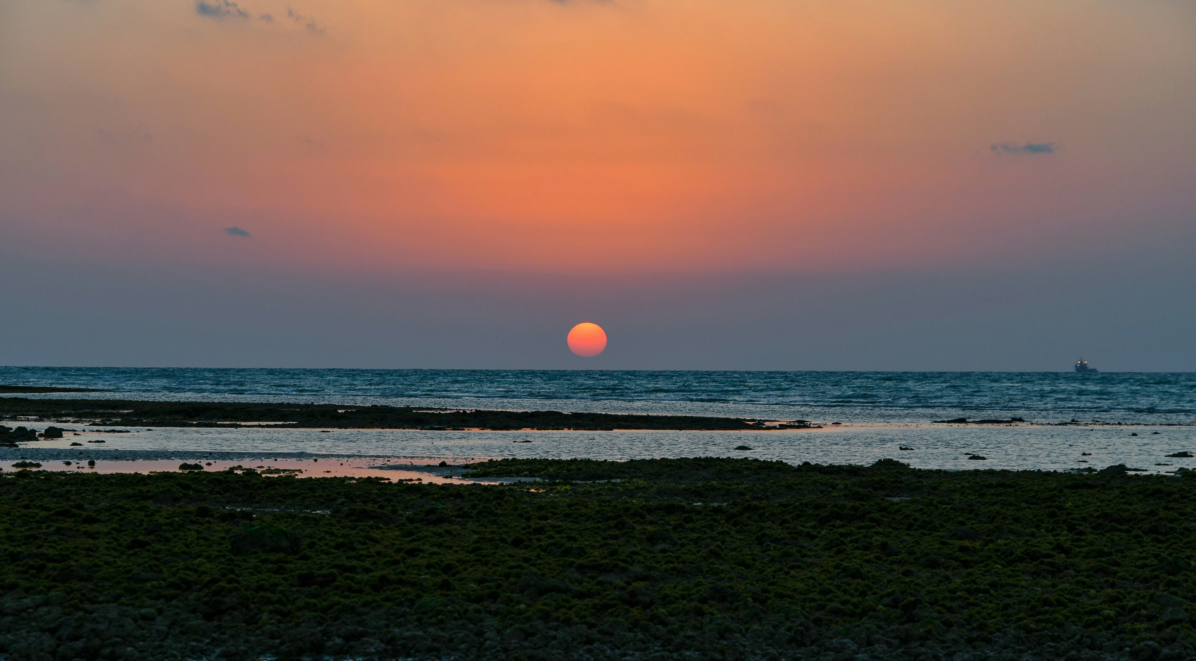 sunset over the beach with ocean