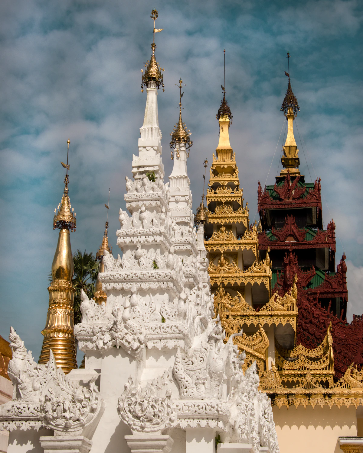 Gold pagoda under white clouds in Myanmar