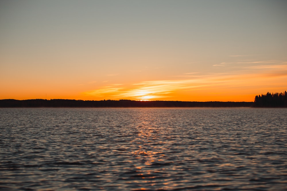 body of water during sunset