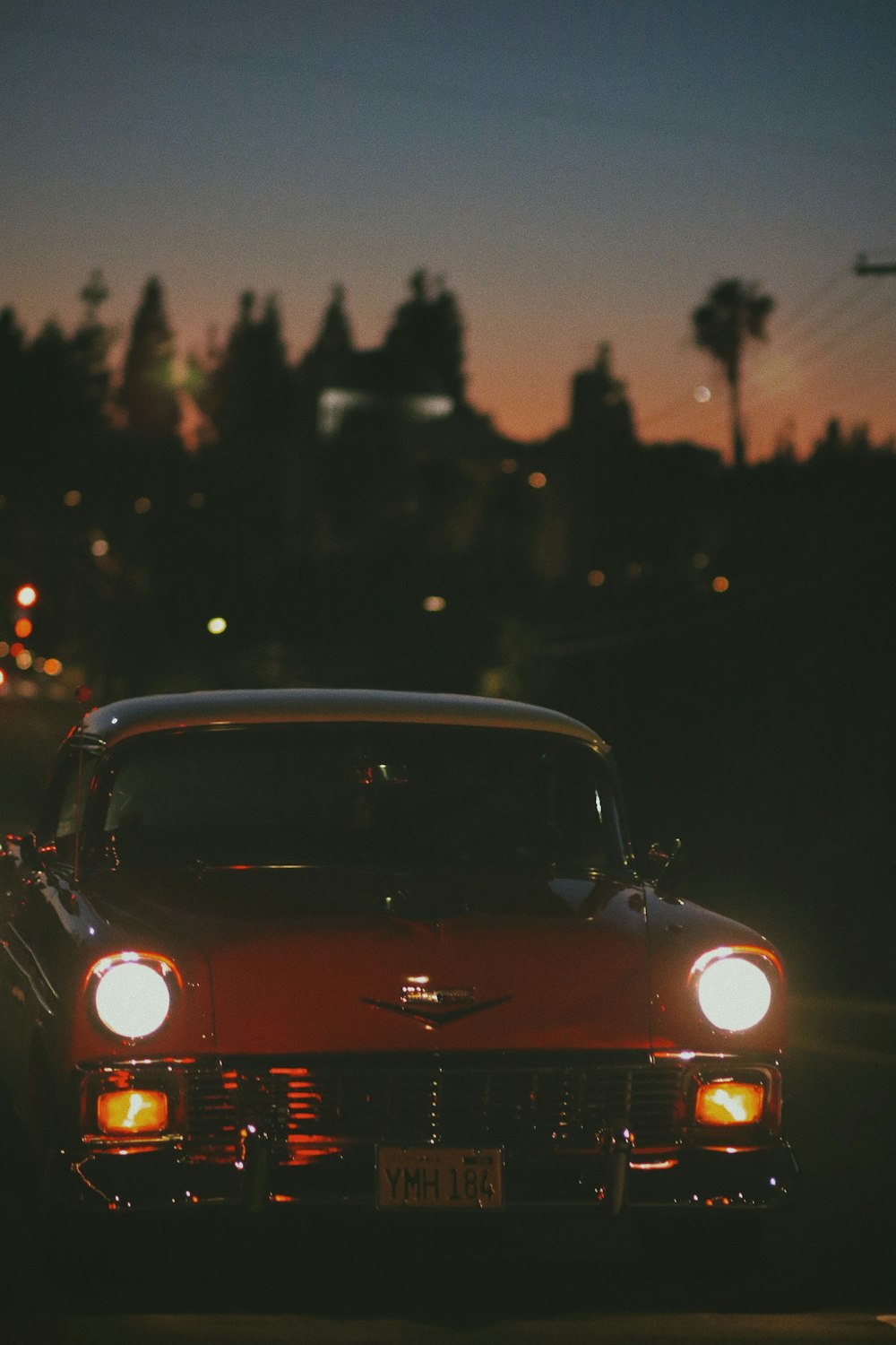 red volkswagen beetle on road during night time