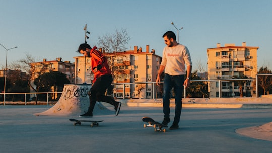 man in white crew neck t-shirt and blue denim jeans standing beside black short coated in Bostanlı Turkey