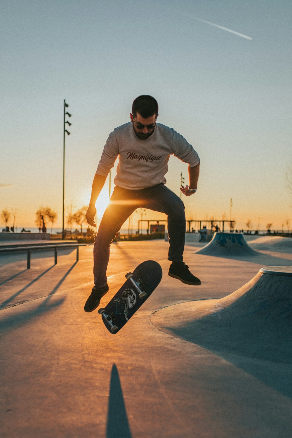 man in white crew neck t-shirt and brown shorts running on basketball court during daytime