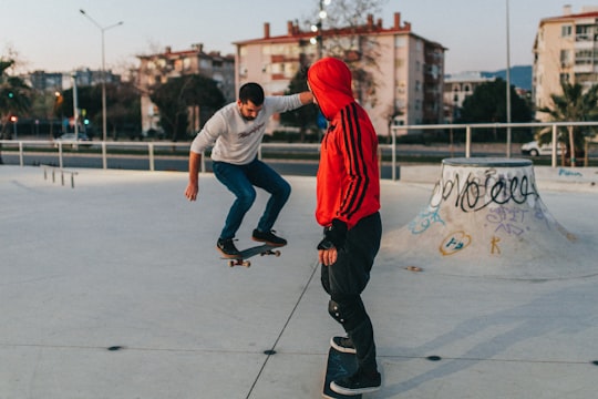 man in white shirt and black pants holding black and white stick in Bostanlı Turkey