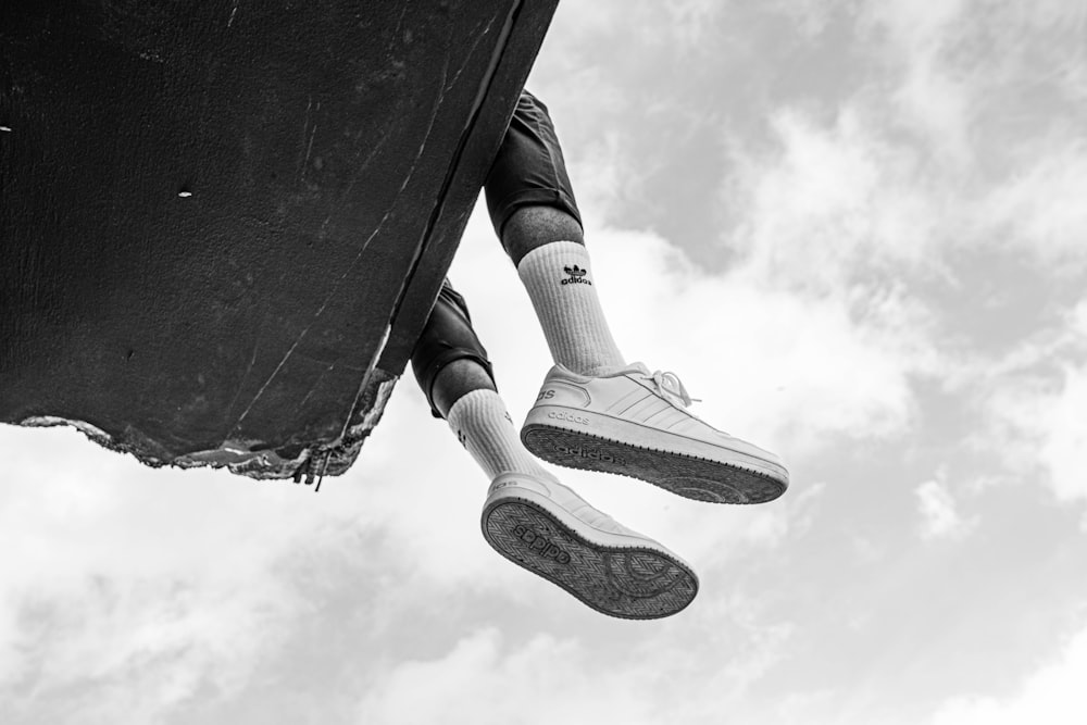 person wearing black and white nike sneakers