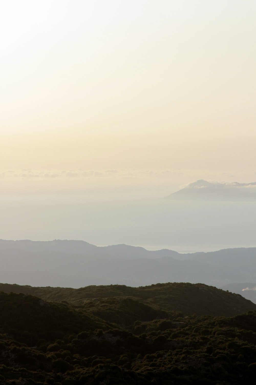 mountain range under white clouds during daytime