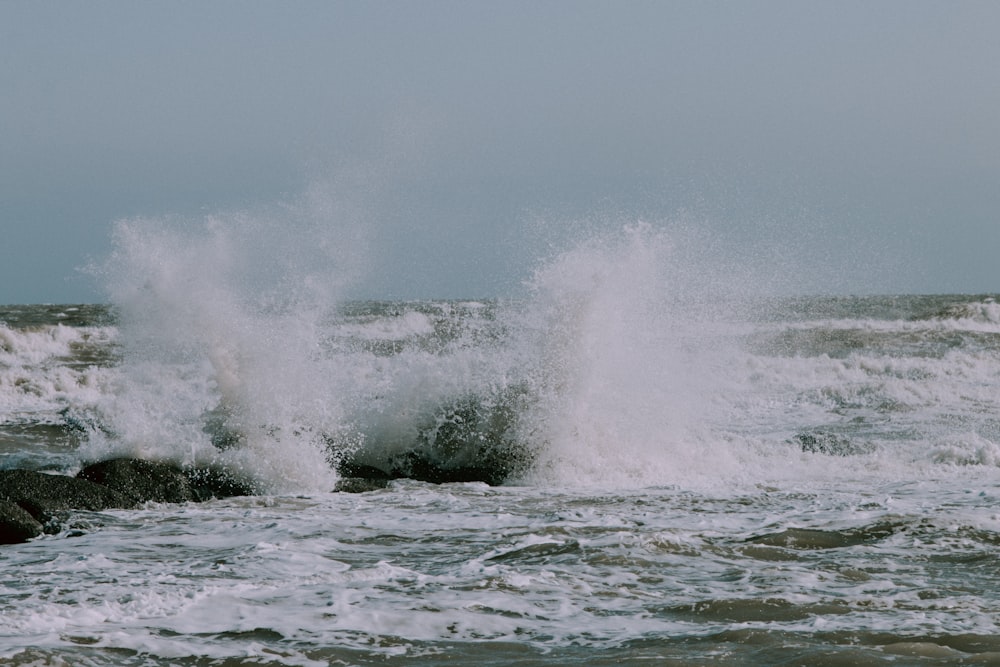 ocean waves crashing on shore during daytime