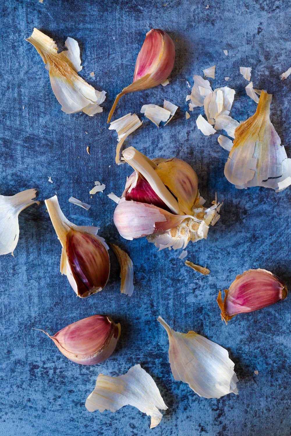 white and brown garlic on gray textile