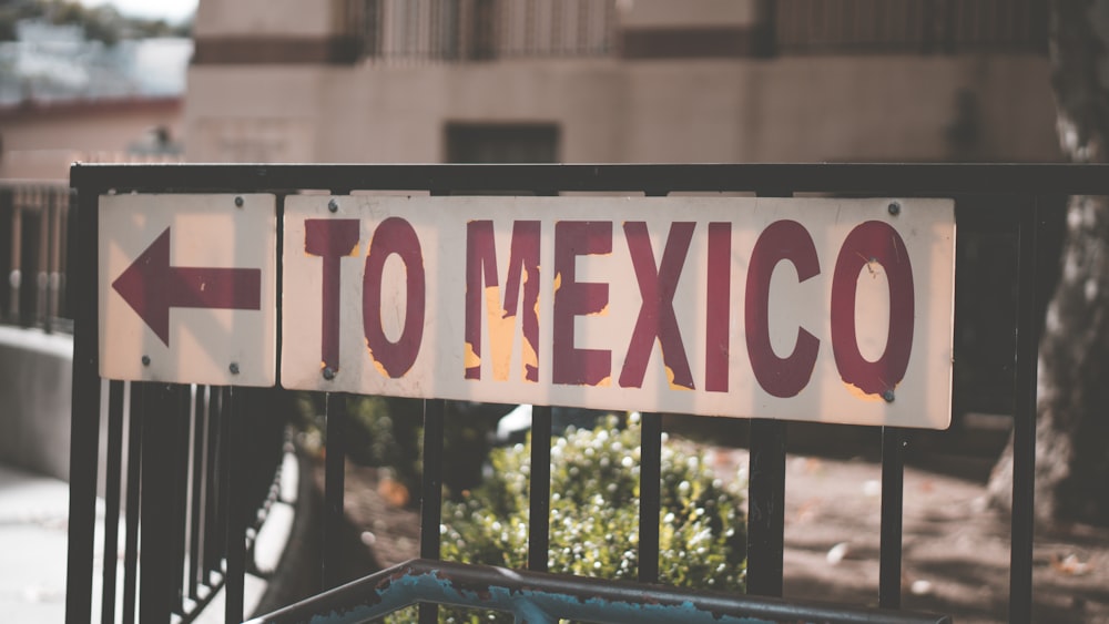 a close up of a street sign with a building in the background