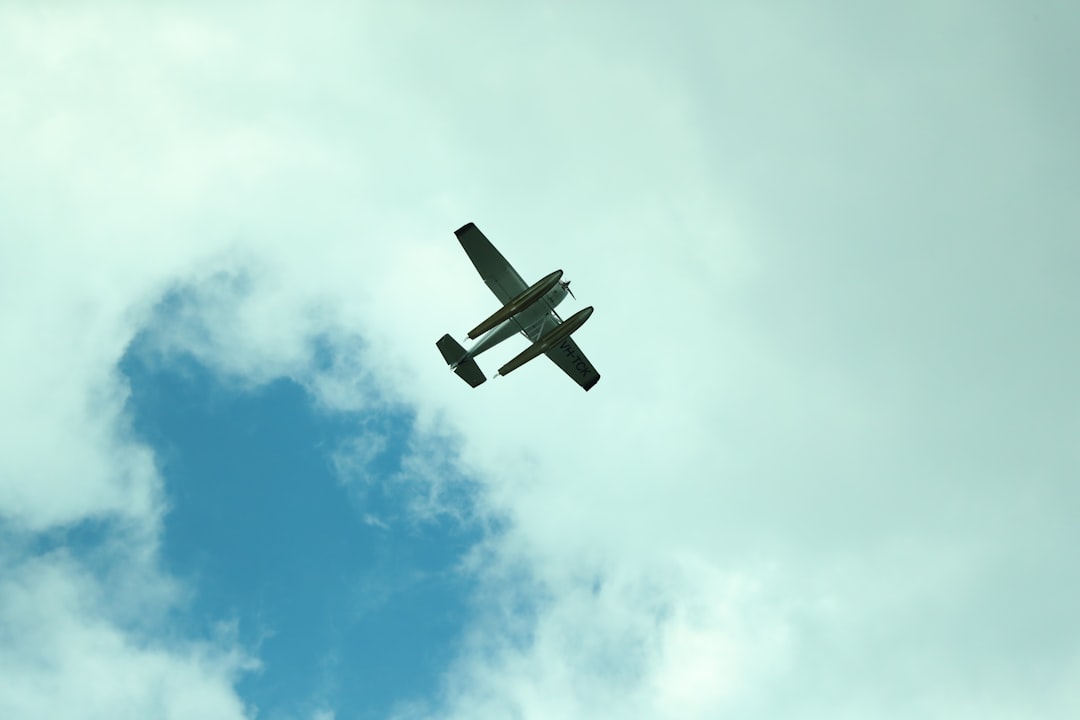 white and black plane in mid air during daytime