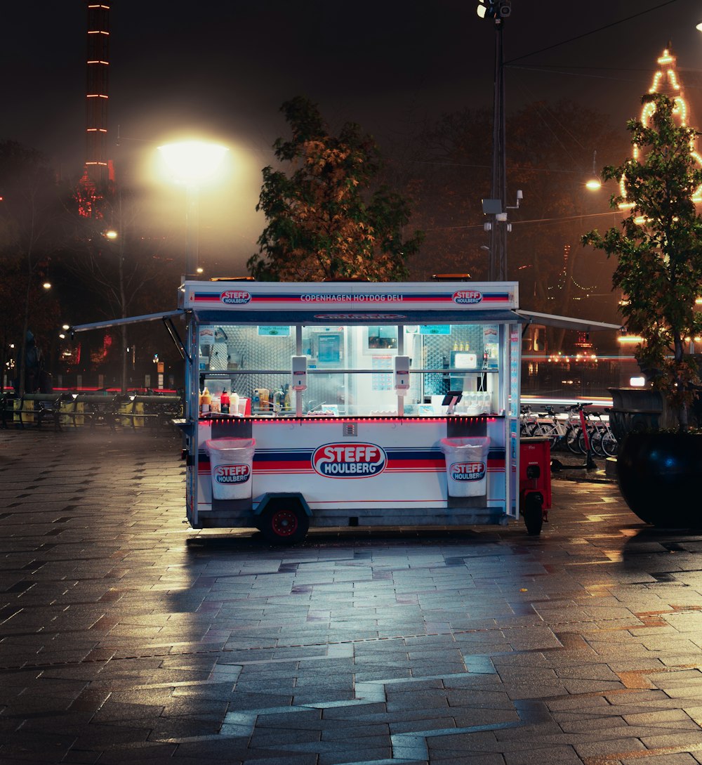 red and white bus on road during night time