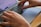 Close-up of hands typing on a laptop with a smooth user interface on screen.