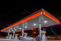 white car parked in front of red and white building during night time