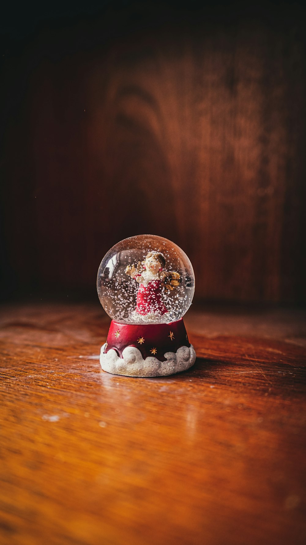 santa claus snow globe on brown wooden table