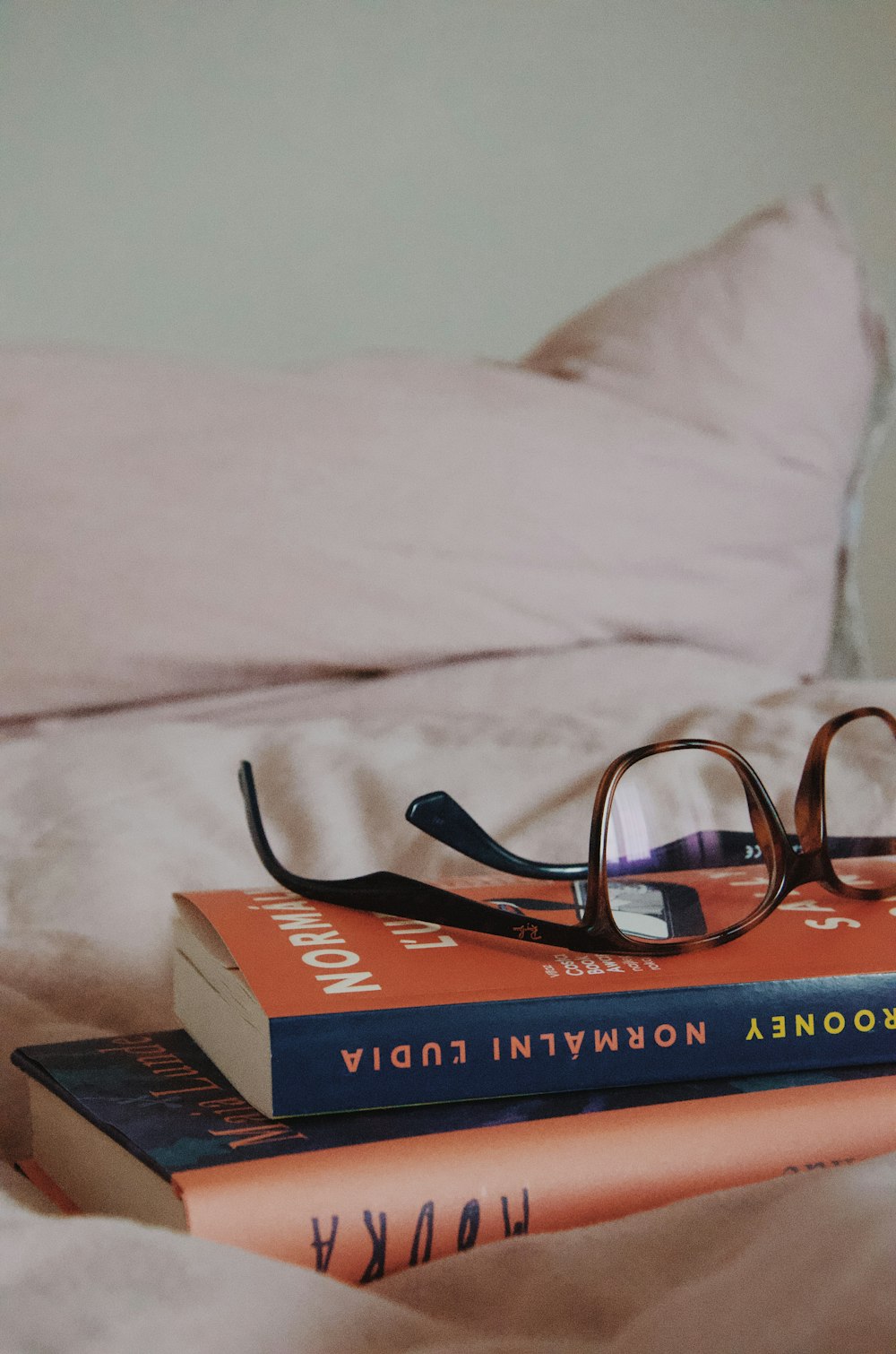 black framed eyeglasses on red and white book