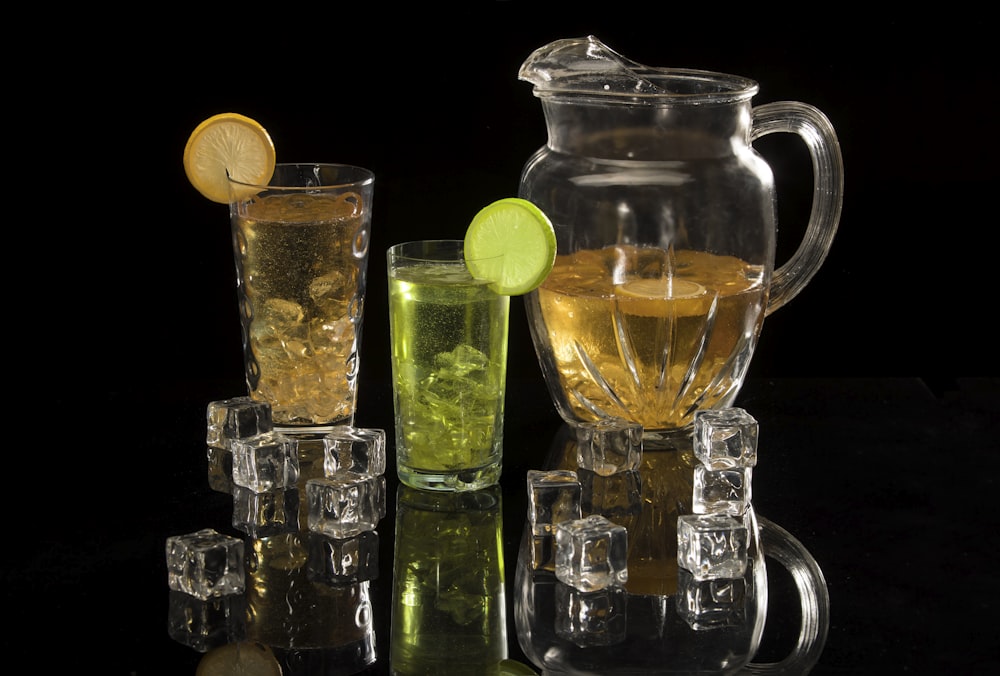 clear glass pitcher with green liquid