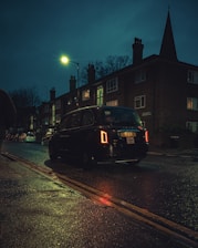 black car on road during night time